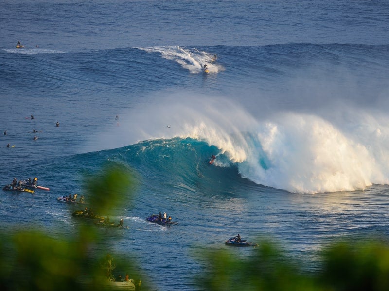 Surfers on massive wave at Pe'ahi Jaws Surf Break, Haiku, Maui