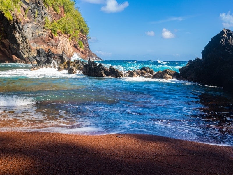 View of ocean from Kaihalulu Beach between rock formations, Hana, Maui