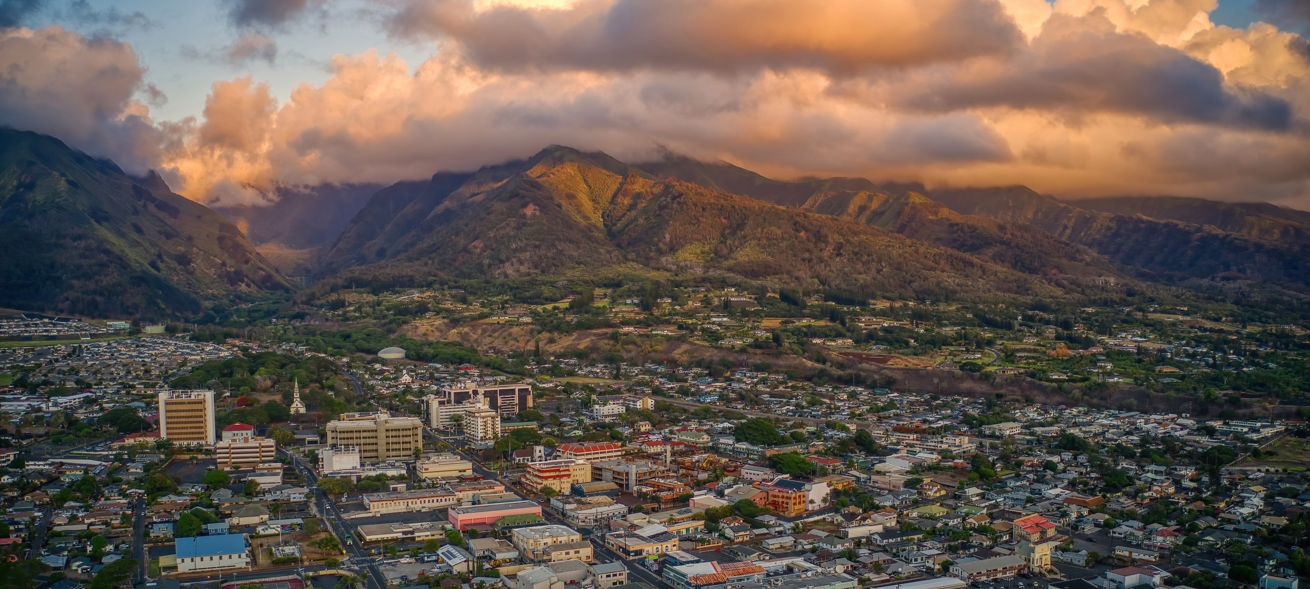 Aerial view over Wailuku, Maui with view of mountains in distance